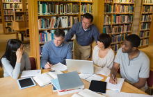Adults working together in a library